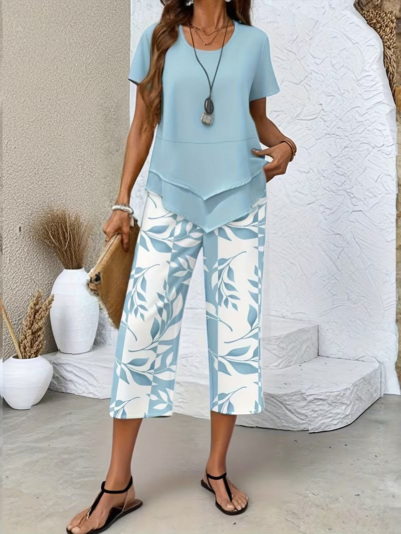 Stylish women's botanical leaf print short sleeve top & matching cropped pants. Relaxed fit two-piece set for comfort.