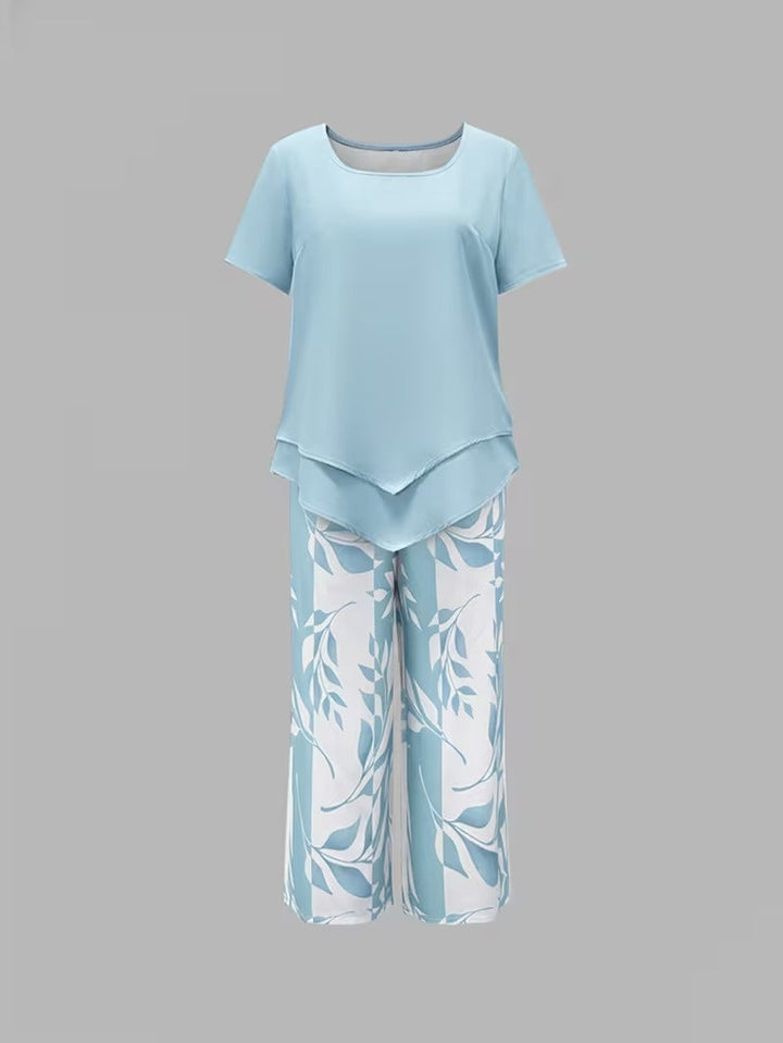 Close-up: Detail of women's botanical leaf print fabric on short-sleeve top & cropped pants outfit.