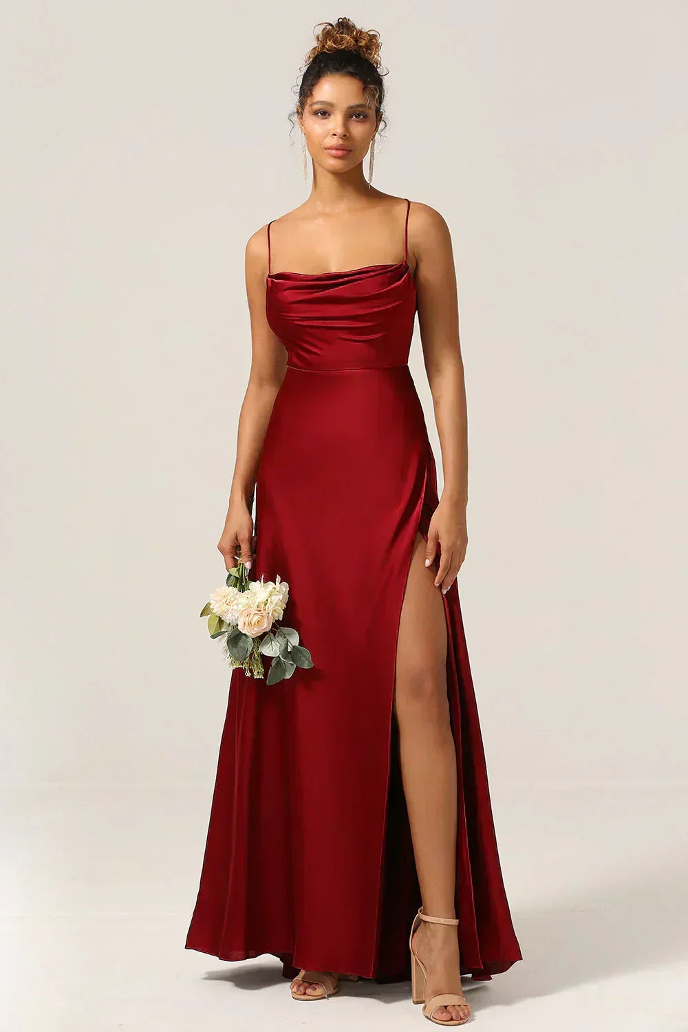 Women's cocktail maxi dress with a flattering open back, high slit, & draped details, perfect for evening wear.
