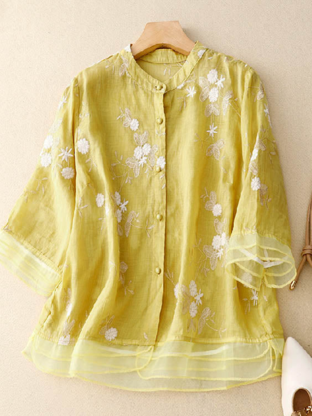 Casual women's button-front blouse with delicate embroidery, long sleeves, loose fit, stylish top.