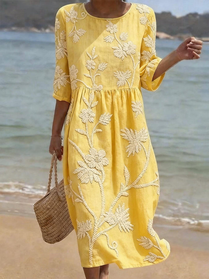 Relaxed fit women's embroidered midi dress with three-quarter sleeves & round neck, perfect for elegant casual.