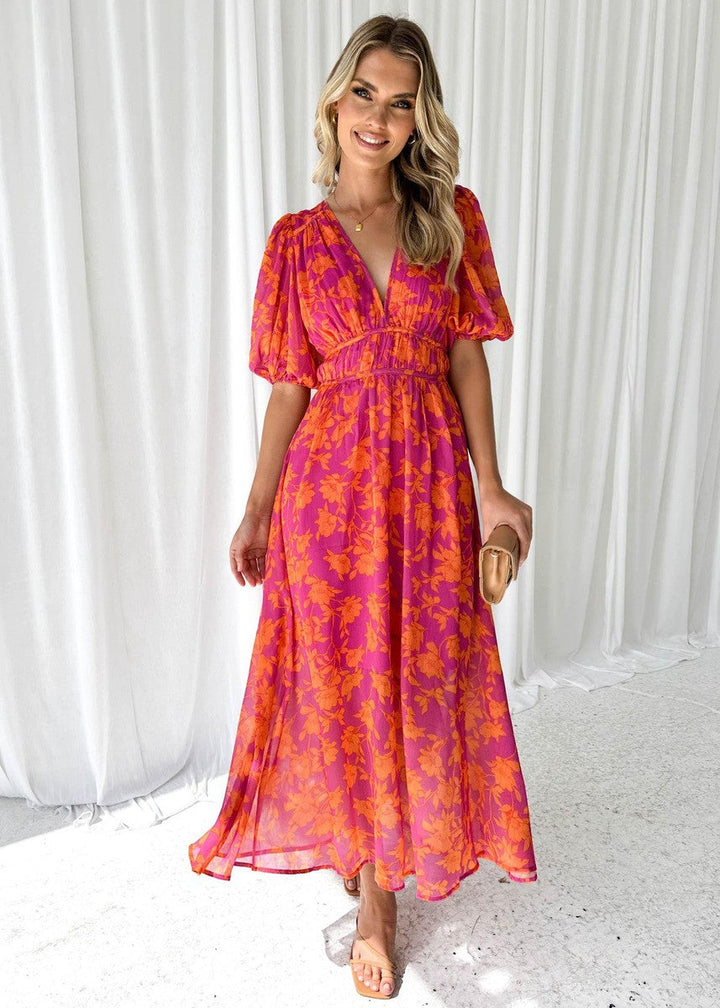Elegant women's floral midi wrap dress, perfect for wedding guests. Features puff sleeves & vibrant spring print.