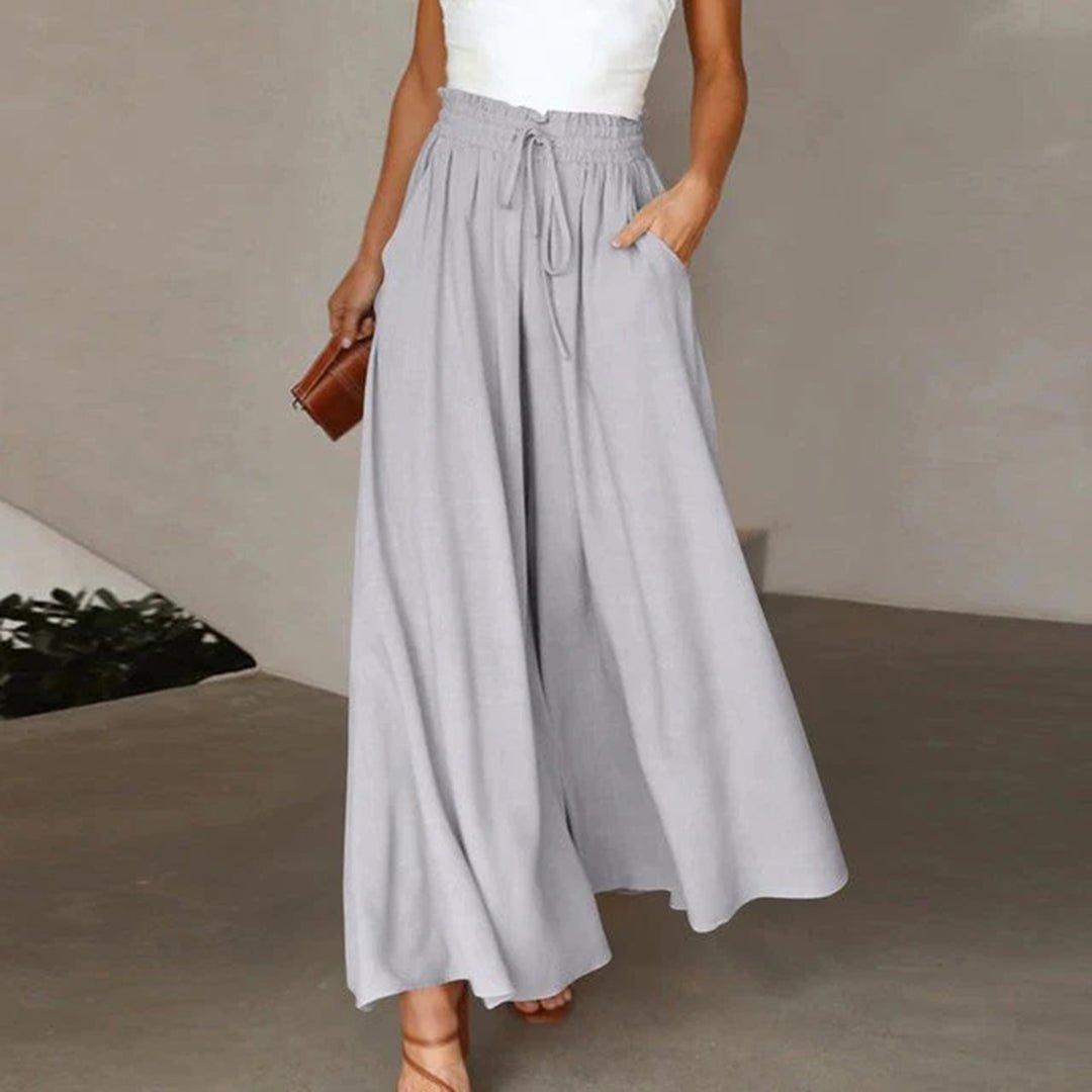 Relaxed fit women's high waist wide leg pants with soft fabric, drawstring, and deep pockets. All-day comfort.