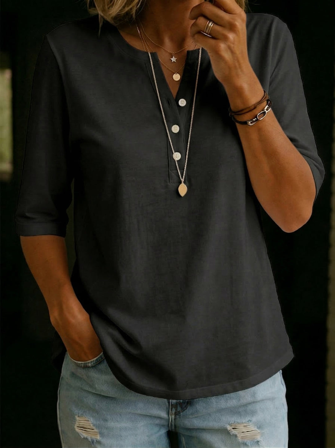 Stylish women's relaxed fit blouse with a chic notch neck and 3/4 sleeves.