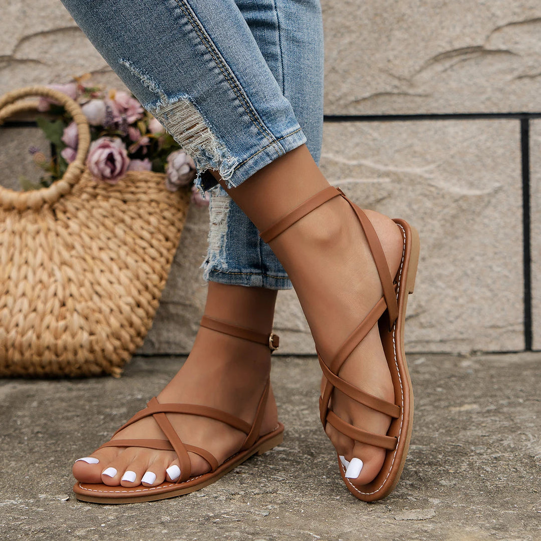 Stylish women's flat sandals: open-toe design, secure ankle strap. Perfect comfortable summer shoes.