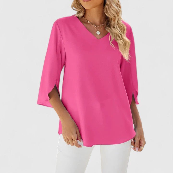 Elegant women's top featuring a V-neck, beautiful ruffles, and trendy split sleeves.