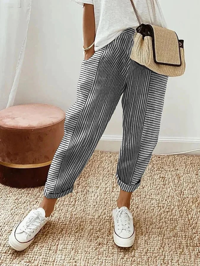 Close-up of women's striped straight-leg trousers, showcasing relaxed fit and comfortable elastic waistband.