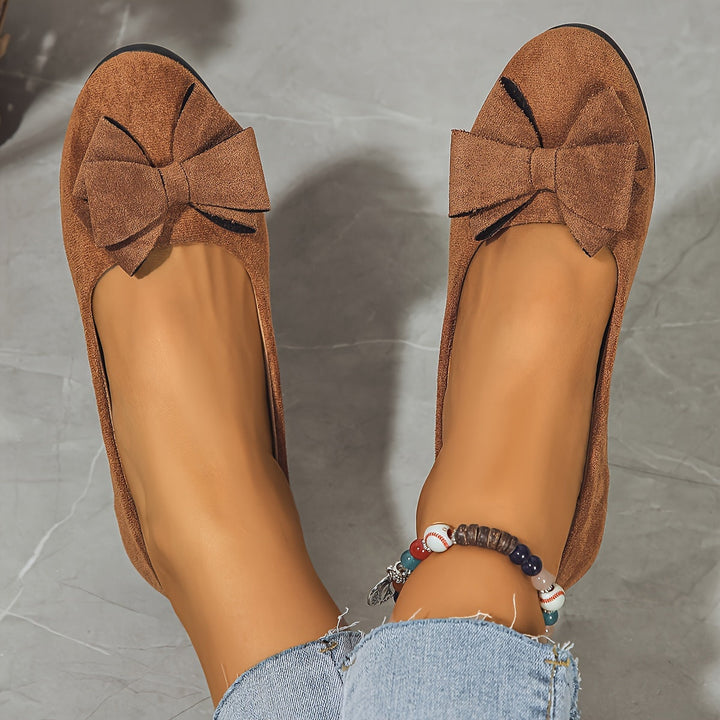 Durable & elegant women's slip-on wedge shoes with bow detail, ideal for comfortable daily wear.