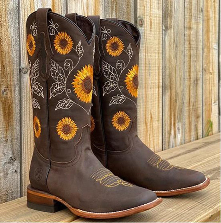 Boho chic mid-calf cowboy boots for women, featuring yellow sunflower embroidery & a stylish scalloped top. Festival ready.