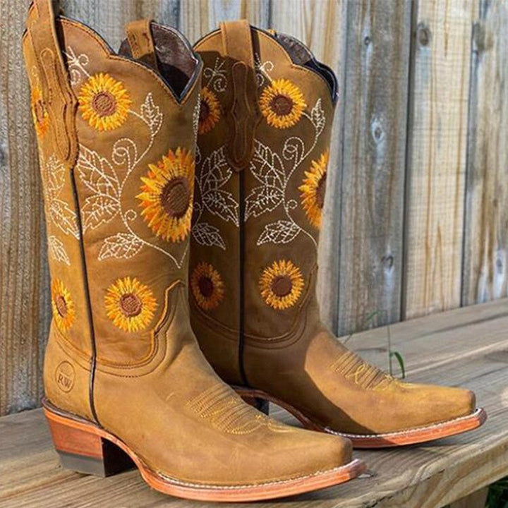 Women's embroidered sunflower western boots, mid-calf height, pointed toe, & block heel for an authentic cowboy style.