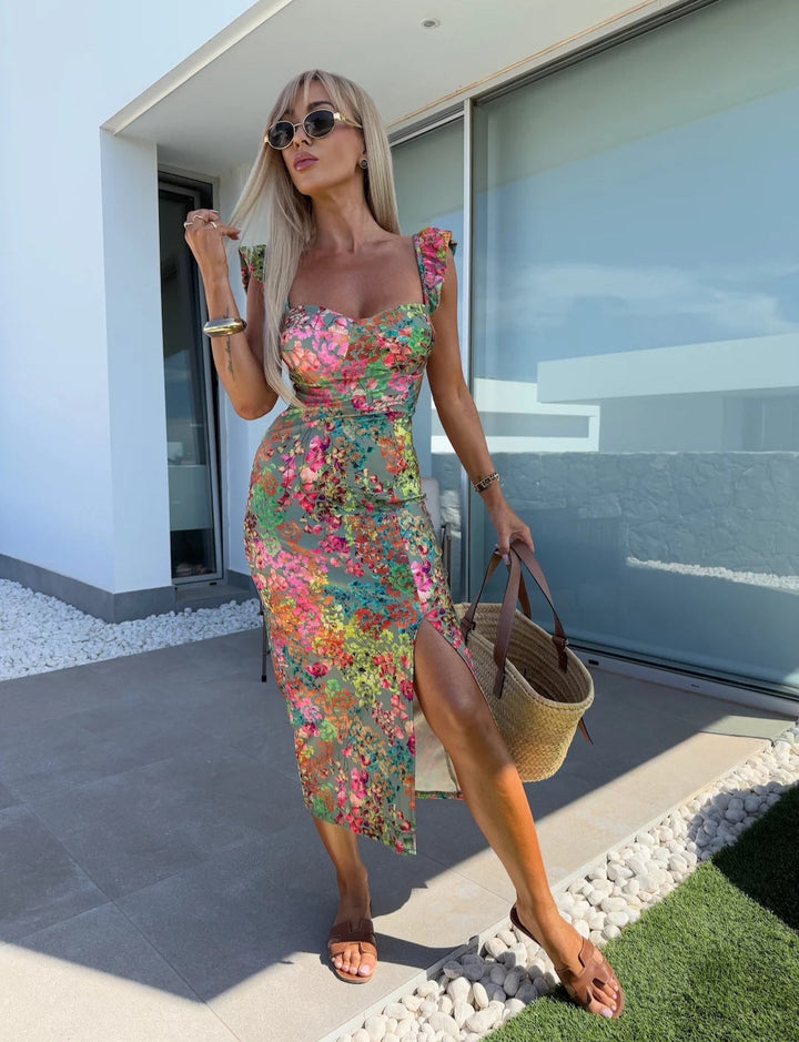 Women's floral midi dress with side slit, sweetheart neckline & ruffle straps, perfect for summer vacation.